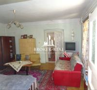 Living room in a family house with a tiled stove and a floor with a wooden decor.