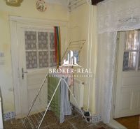 Interior of a family house with doors, curtains, and a clothes drying rack.
