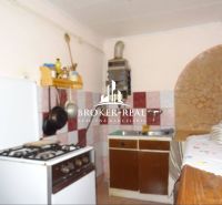 A kitchen in a family house with a gas stove and rustic accessories.
