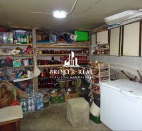 A compact cellar with shelves for preserves and storage space in a family house.