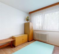 A simple room in a family house with furniture and flooring featuring a wooden decor.
