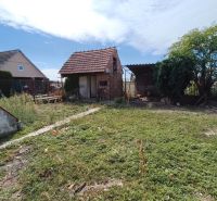 Garden at the family house on 1st May Street in Brodské with a utility building.