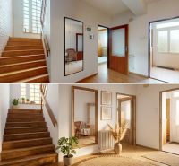 A hallway in a family house with a wooden decor floor, plants, and mirrors.