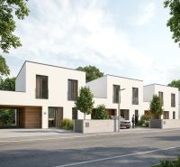 Row houses in Skalica, residential plots. Modern architecture, green trees line the street.