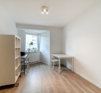 A study in a 3-room apartment with a wooden decor floor and simple furniture.