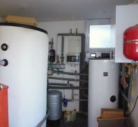 Boilers and tanks in warehouse and hall spaces with piping and accessories.