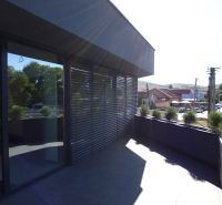 Terrace near warehouses and halls in Kračúnovce with a view of the street and greenery.
