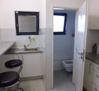 Kitchen corner with chairs and a sink, the door leads to the toilet in the Warehouses and Halls.