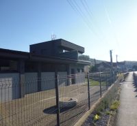 Industrial building in Kračúnovce, warehouses and halls by the main road behind the fence.