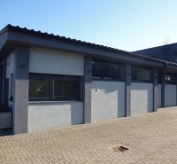 Warehouses and halls in Kračúnovce with concrete paving and modern architecture.
