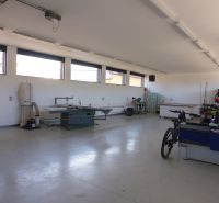 Interior with technical equipment and a bicycle in warehouse and hall spaces.
