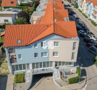 Buildings with orange roofs and a parking lot in Bratislava III.
