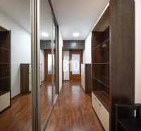 A hallway with a wooden decor floor and built-in wardrobes in a 2-room apartment.