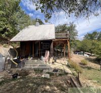 A cottage in Bratislava IV with a wooden shelter in a natural environment.