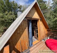 Wooden cottage with a terrace in the natural environment of Bratislava IV surrounded by greenery.