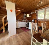Interior of a cottage with a kitchen and a wooden decor floor.