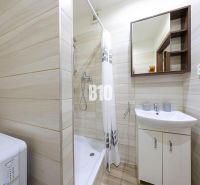 A bathroom in a 3-room apartment with a washing machine and a shower.