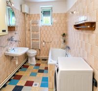 A bathroom in a family house with a shower, a bathtub, and mosaic flooring.
