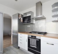 A kitchen in a 4-room apartment with a wooden decor and built-in appliances.