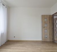 Interior of a 4-room apartment with a wooden decor floor and a large window.