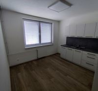 Offices with a kitchenette and flooring with a wood decor.