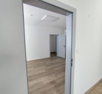 Offices with wood-patterned flooring and white walls.