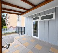 Commercial premises in Komárno with glass entrance doors and a terrace canopy.
