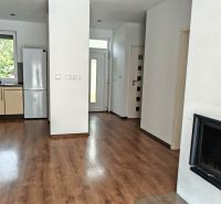 A family house kitchen with a wooden decor floor and a built-in fireplace.