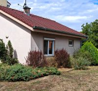 A family house in Matúškovo with a red roof and a well-maintained front garden.