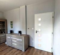 Interior of a family house with a wooden decor floor and modern furniture.