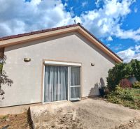 A family house in Matúškovo with a terrace and a garden with lush greenery.