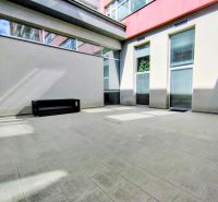 Outdoor terrace of offices on Bajkalská in Bratislava - Ružinov with paving and a bench.