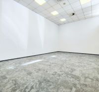 Bright commercial spaces with white walls and gray carpeted flooring.