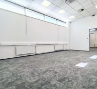 Bright commercial spaces with carpet and suspended ceiling, white walls, open doors.