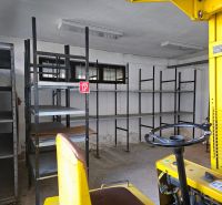 There are shelves and a yellow forklift in the garage, ready for storage.