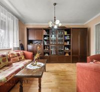 Living room in a family house with a wooden decor floor, furniture, and sofas.