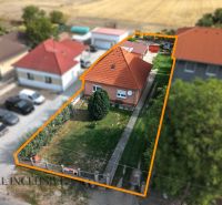 A family house in Povoda with a red roof and a landscaped garden surrounded by greenery.
