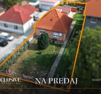 A family house in Povoda surrounded by a garden and a paved driveway.
