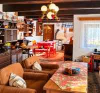 Interior of a cottage with antique furniture and traditional kitchen accessories.