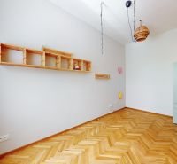 Interior of a 4-room apartment with a wooden decor floor and light furniture.