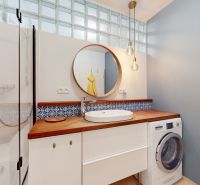 A bathroom in a 4-room apartment with a shower, sink, and washing machine.