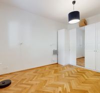 A room in a 4-room apartment with a wooden decor floor and a built-in wardrobe.