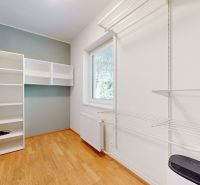 A small room with a shelving storage system and a wooden decor floor.