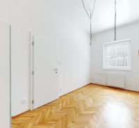 A room with a light coating and a floor with a wood decor in a 4-room apartment.