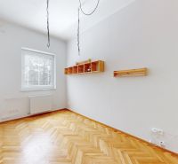 An empty room with shelves and a wooden floor decor in a 4-room apartment.