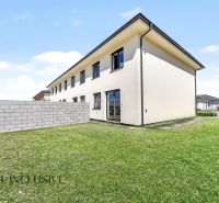 A family house in Dolný Bar with two floors and a green lawn.