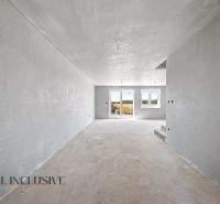 A view of a spacious interior in a family house with a concrete floor.