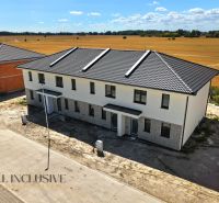 A family house in Dolný Bar with a sloped roof, located in the countryside.