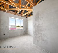 Gray walls and wooden beams in the interior of a family house.