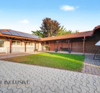 Family house in Kostolné Kračany, Dunajská Streda with a paved courtyard and solar panels.